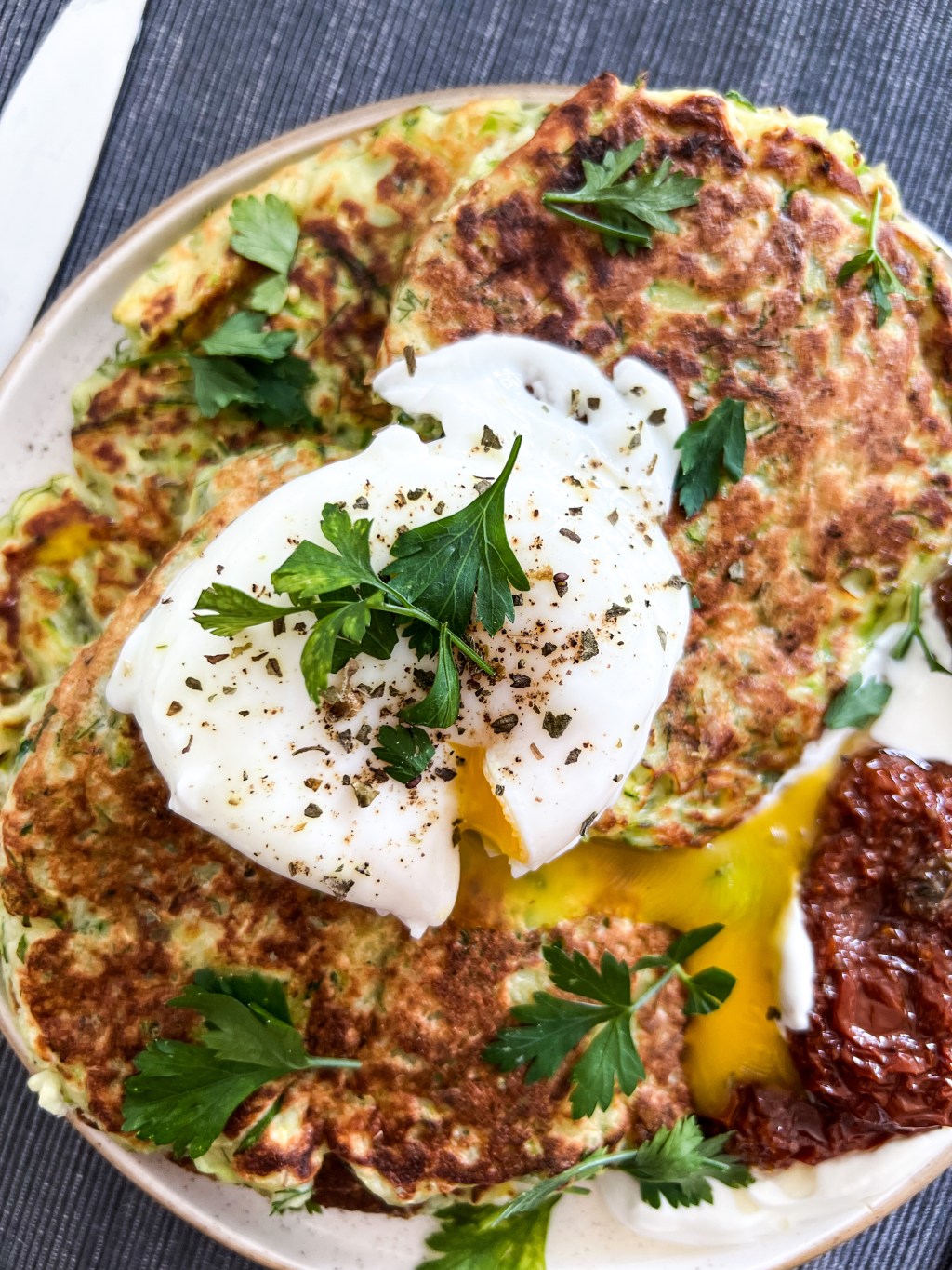 Zucchini fritters with poached egg and dried tomatoes